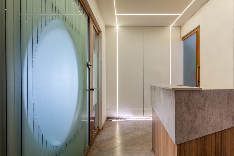 The reception at Microtel, in backlit glass and stone.